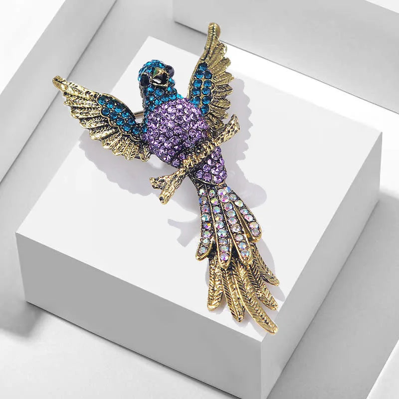 The Bird of Paradise Brooch on a white gift box