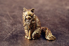Maisie the Maine Coon bronze figurine on a grey stone background