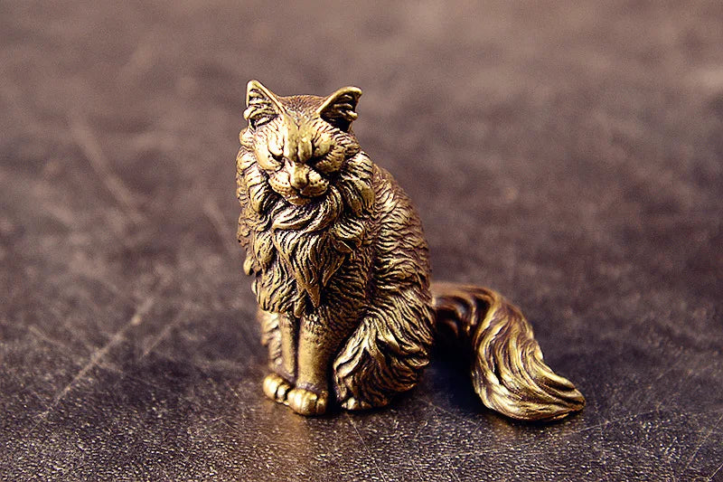 Maisie the Maine Coon bronze figurine on a grey stone background