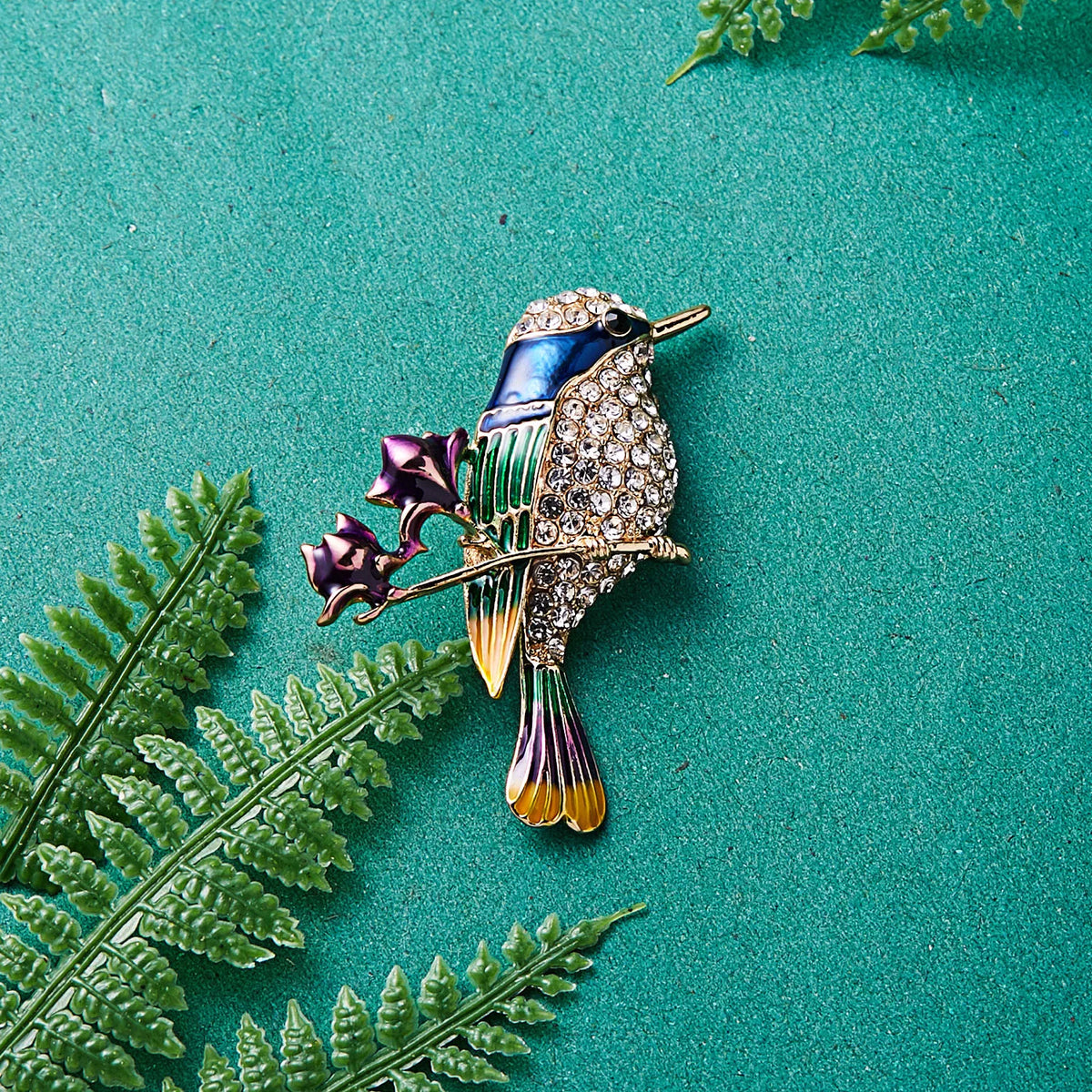 The Jewelled Kingfisher Brooch with green fern leaves