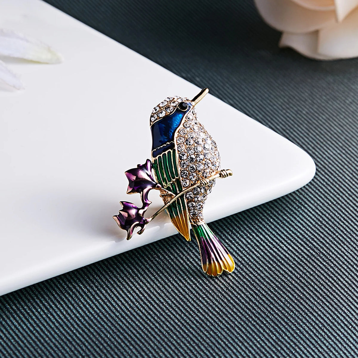 The Jewelled Kingfisher Brooch on a dark background